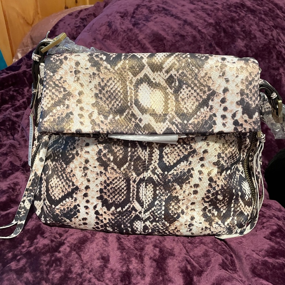 Outside Leather, inside lining is polyester. Measurements 14” wide 11” tall.